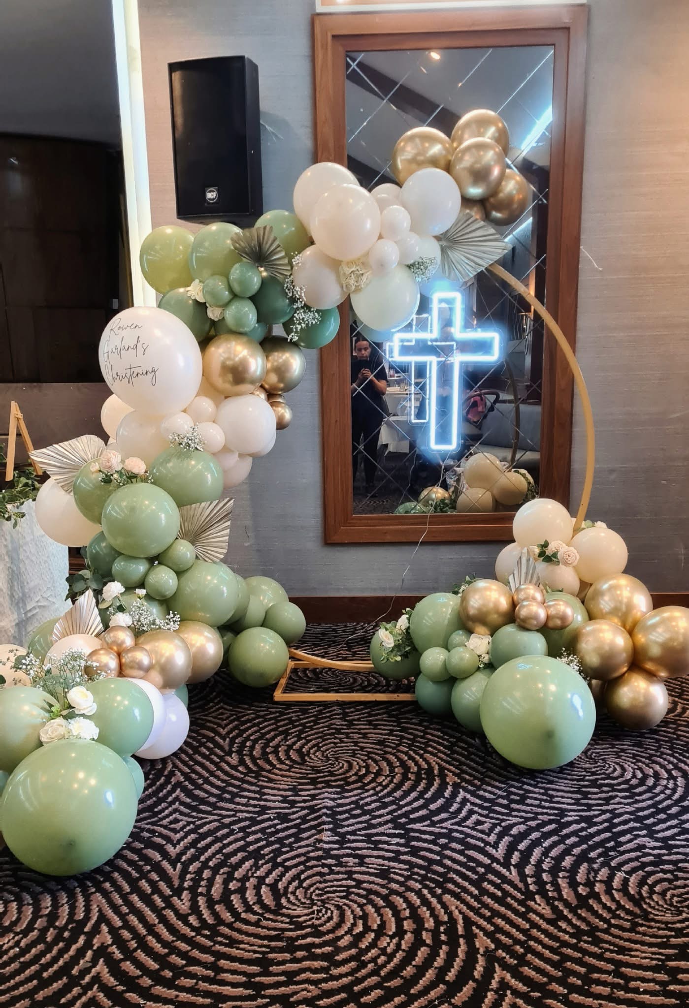 Christening balloon arch with neon cross in green and gold